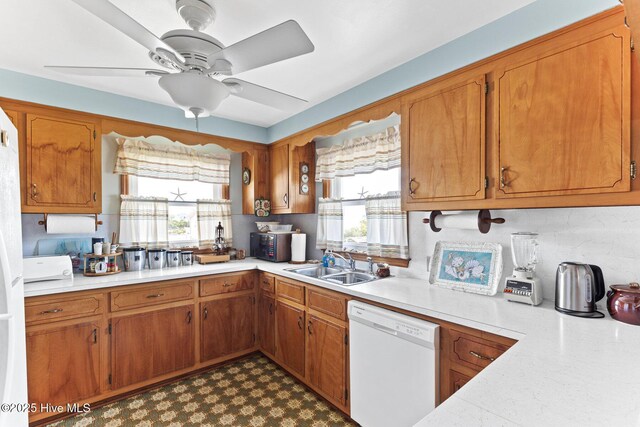 713 Channel Blvd, Topsail Beach, NC 28445 - kitchen with light countertops, brown cabinets, a healthy amount of sunlight, and dishwasher