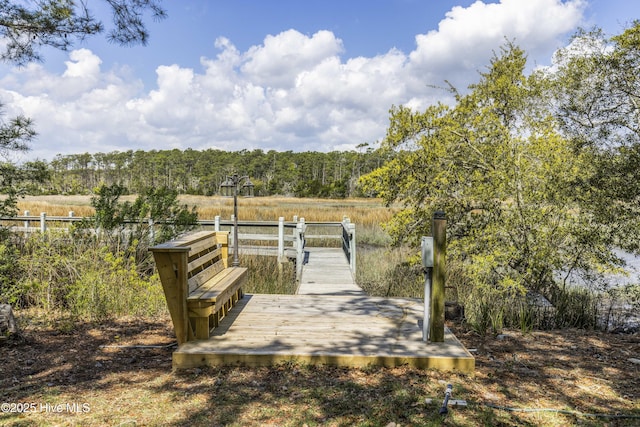 view of dock with a forest view