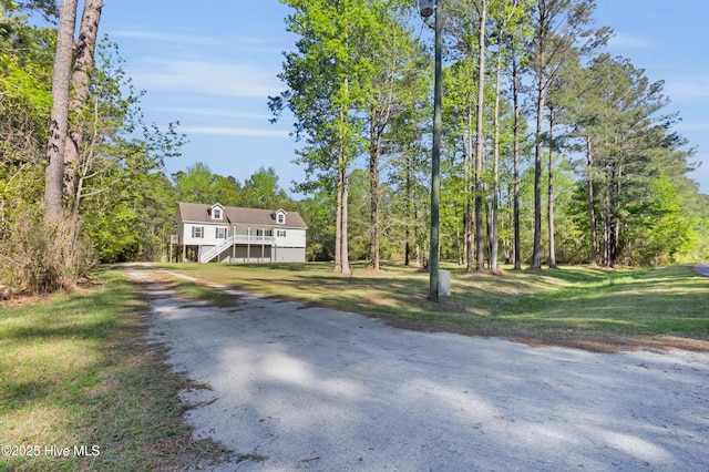 318 Winchester Way, Merritt, NC 28556 - view of front of house with dirt driveway, a front lawn, and stairway