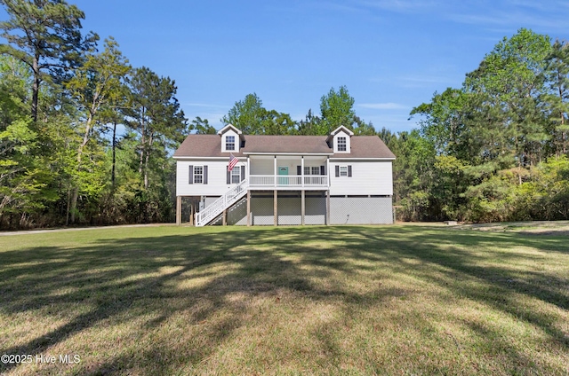 318 Winchester Way, Merritt, NC 28556 - back of property with a lawn, stairway, and a deck
