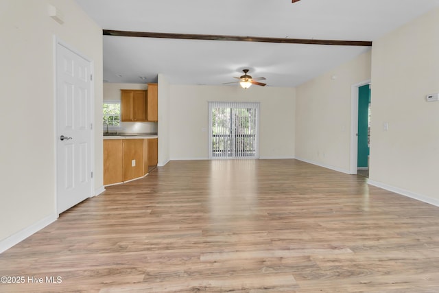 318 Winchester Way, Merritt, NC 28556 - unfurnished living room featuring ceiling fan, a healthy amount of sunlight, and light wood-style floors
