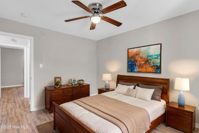 bedroom featuring light wood-style flooring, baseboards, and ceiling fan