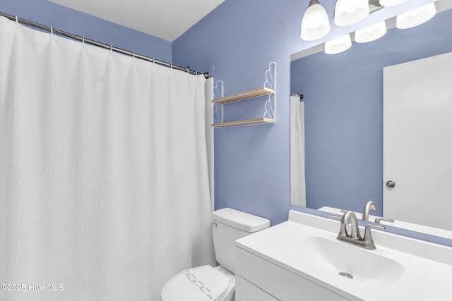 full bathroom with toilet and vanity