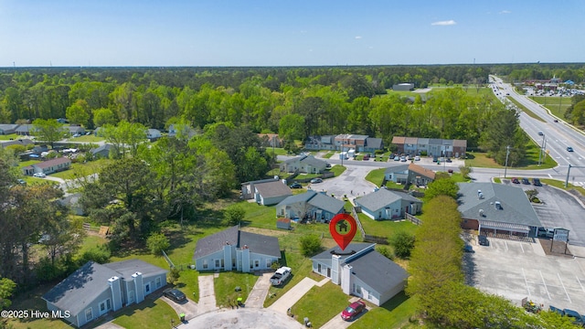 birds eye view of property featuring a view of trees and a residential view