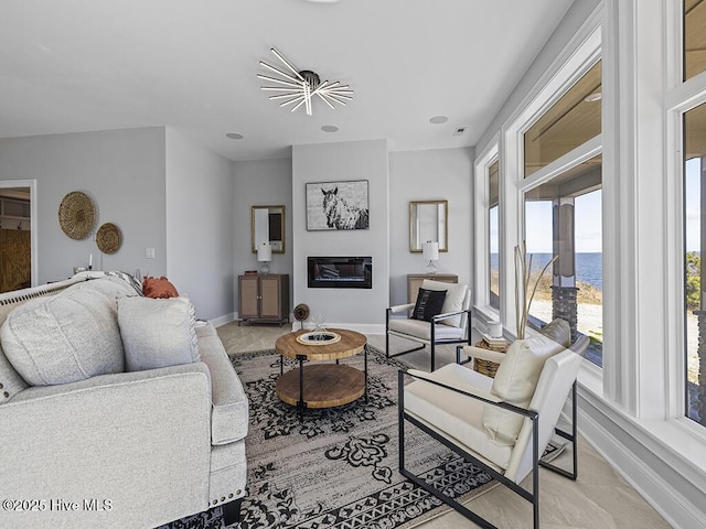 371 Narrow Shore Rd, Aydlett, NC 27916 - living room with a water view, baseboards, and light carpet