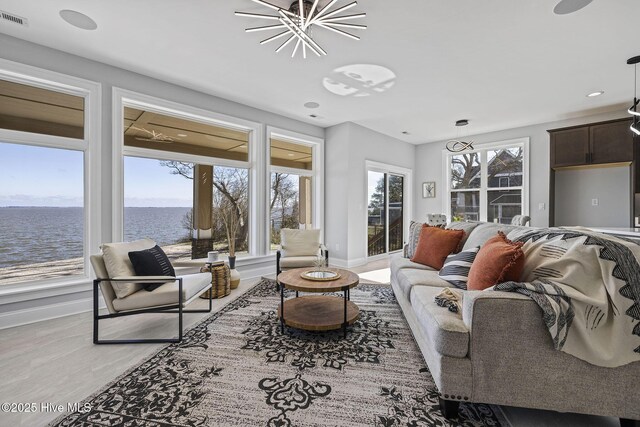 371 Narrow Shore Rd, Aydlett, NC 27916 - living area featuring a chandelier, a water view, wood finished floors, baseboards, and recessed lighting