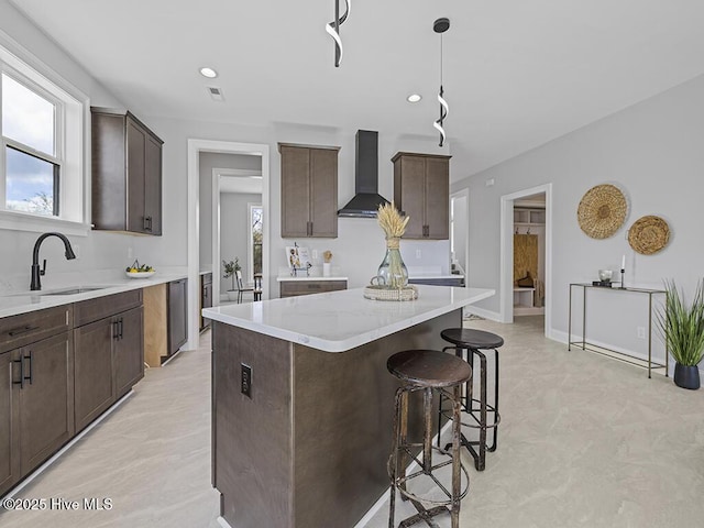 371 Narrow Shore Rd, Aydlett, NC 27916 - kitchen with wall chimney range hood, a sink, dark brown cabinets, a center island, and recessed lighting