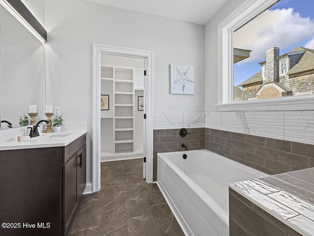 371 Narrow Shore Rd, Aydlett, NC 27916 - full bathroom featuring a walk in closet, a garden tub, marble finish floors, and vanity