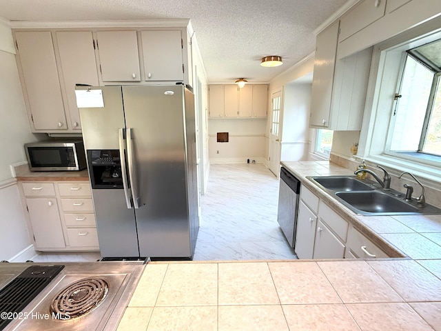 114 Long Leaf Ln, Plymouth, NC 27962 - kitchen with a sink, stainless steel appliances, baseboards, and tile counters