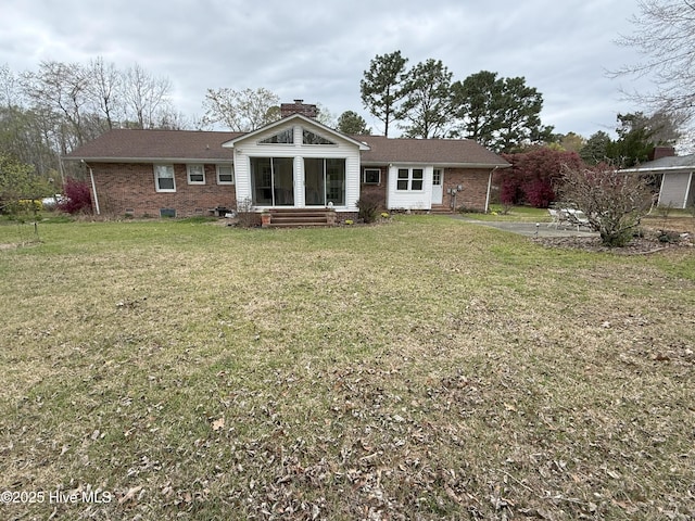 114 Long Leaf Ln, Plymouth, NC 27962 - back of property with brick siding, a chimney, and a lawn