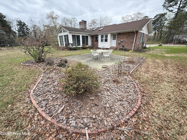 114 Long Leaf Ln, Plymouth, NC 27962 - back of property featuring a chimney, a yard, a patio, and brick siding