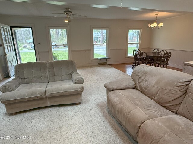 114 Long Leaf Ln, Plymouth, NC 27962 - carpeted living room with wainscoting and ceiling fan with notable chandelier