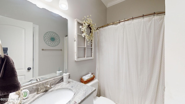 bathroom featuring a shower with shower curtain, toilet, ornamental molding, and vanity