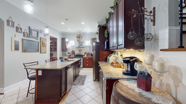 kitchen featuring crown molding, stainless steel appliances, light stone counters, a breakfast bar area, and backsplash