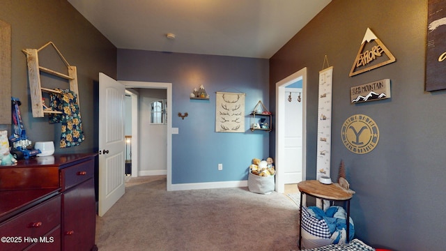 interior space featuring carpet floors and baseboards