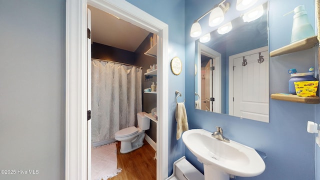 full bathroom with a sink, toilet, a shower with curtain, and wood finished floors
