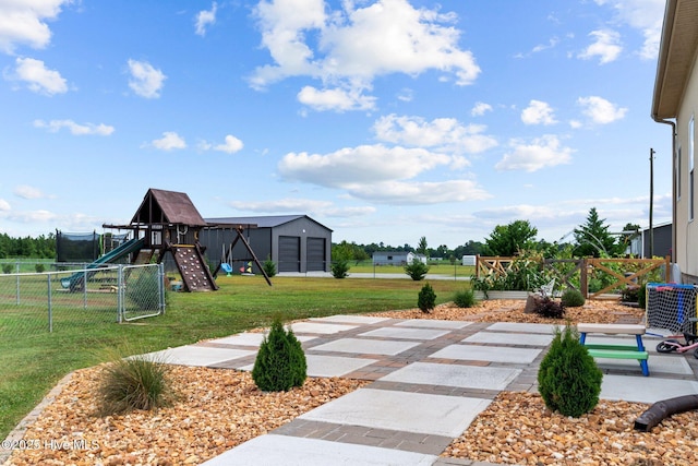 view of yard featuring playground community and fence
