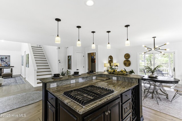 8050 Rachel Wynd Rd NE, Leland, NC 28451 - kitchen with open floor plan, light wood-type flooring, a center island, a chandelier, and stainless steel gas stovetop