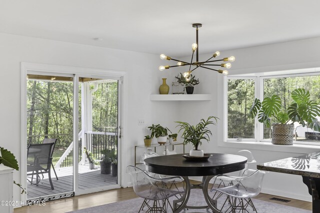 8050 Rachel Wynd Rd NE, Leland, NC 28451 - dining area with visible vents, wood finished floors, and a chandelier