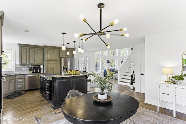8050 Rachel Wynd Rd NE, Leland, NC 28451 - dining space with stairway, baseboards, wood finished floors, and a chandelier