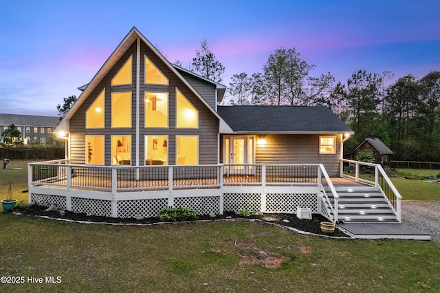 8050 Rachel Wynd Rd NE, Leland, NC 28451 - back of house at dusk featuring a wooden deck and a yard