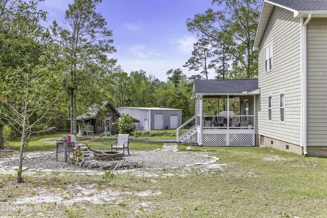 8050 Rachel Wynd Rd NE, Leland, NC 28451 - view of yard with an outdoor structure, a fire pit, and a porch