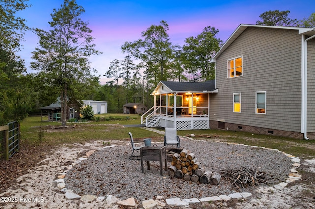 8050 Rachel Wynd Rd NE, Leland, NC 28451 - back of house featuring a wooden deck, a fire pit, and crawl space