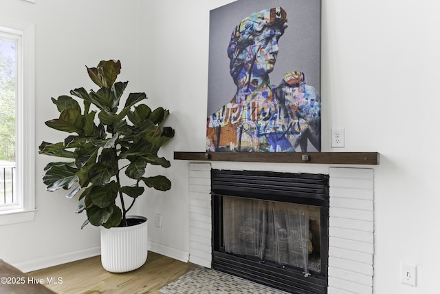 8050 Rachel Wynd Rd NE, Leland, NC 28451 - details with baseboards, a fireplace, and wood finished floors