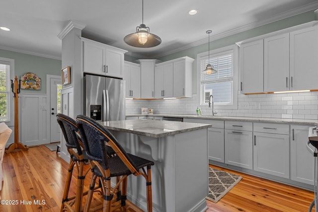 15 Station Ave, Southern Pines, NC 28387 - kitchen featuring appliances with stainless steel finishes, decorative backsplash, a sink, and ornamental molding