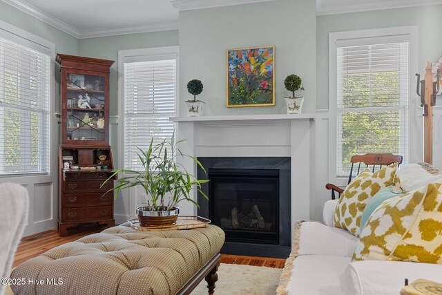 15 Station Ave, Southern Pines, NC 28387 - living room with a fireplace with flush hearth, ornamental molding, and wood finished floors