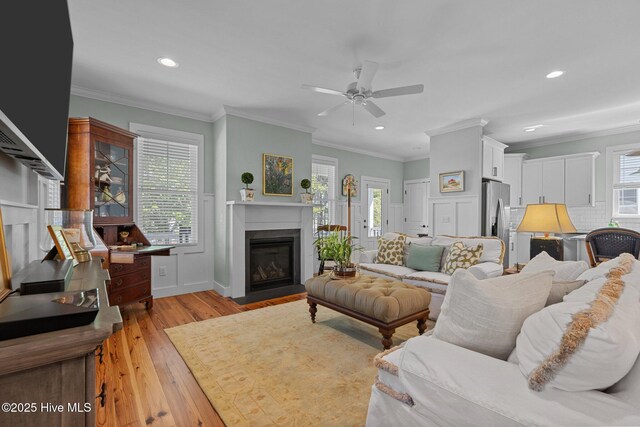 15 Station Ave, Southern Pines, NC 28387 - living area featuring ceiling fan, a wealth of natural light, a fireplace with flush hearth, light wood-type flooring, and recessed lighting