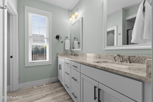 15 Station Ave, Southern Pines, NC 28387 - bathroom with a sink, baseboards, and plenty of natural light