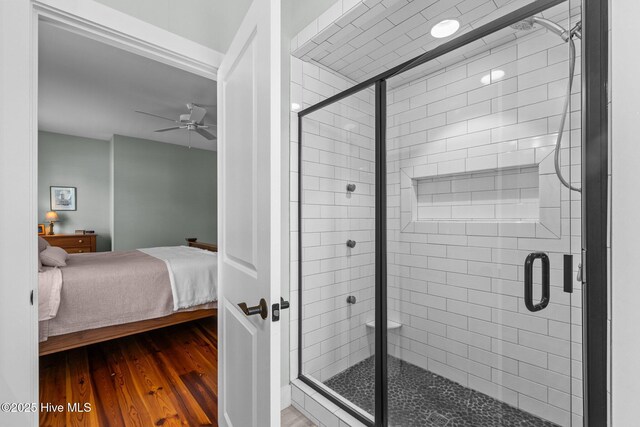 15 Station Ave, Southern Pines, NC 28387 - ensuite bathroom featuring a stall shower, wood finished floors, ensuite bathroom, and ceiling fan