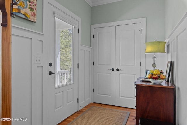 15 Station Ave, Southern Pines, NC 28387 - entryway featuring crown molding, wood finished floors, wainscoting, and a decorative wall