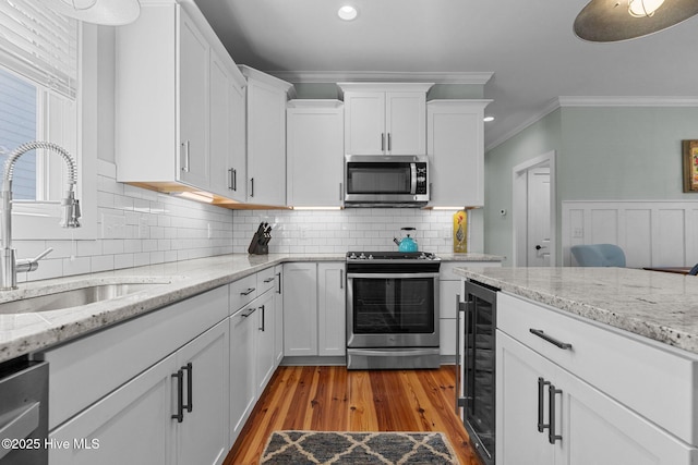 15 Station Ave, Southern Pines, NC 28387 - kitchen featuring white cabinetry, recessed lighting, a sink, beverage cooler, and stainless steel appliances