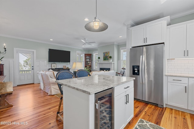 15 Station Ave, Southern Pines, NC 28387 - kitchen with stainless steel fridge with ice dispenser, open floor plan, beverage cooler, and crown molding