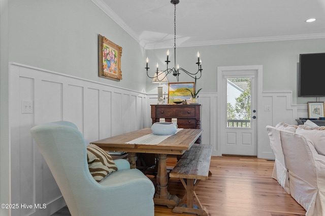 15 Station Ave, Southern Pines, NC 28387 - dining area with a chandelier, a decorative wall, ornamental molding, and light wood-style flooring