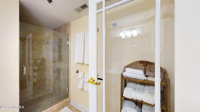 bathroom with tile patterned floors, visible vents, and a stall shower