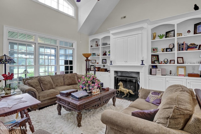 9278 Checkerberry Sq NW, Calabash, NC 28467 - living area with a towering ceiling, a high end fireplace, and built in features