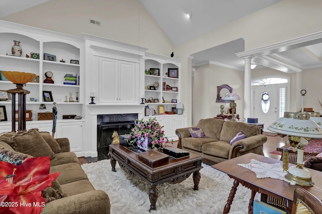 9278 Checkerberry Sq NW, Calabash, NC 28467 - living room with a premium fireplace, lofted ceiling, built in shelves, decorative columns, and ornamental molding