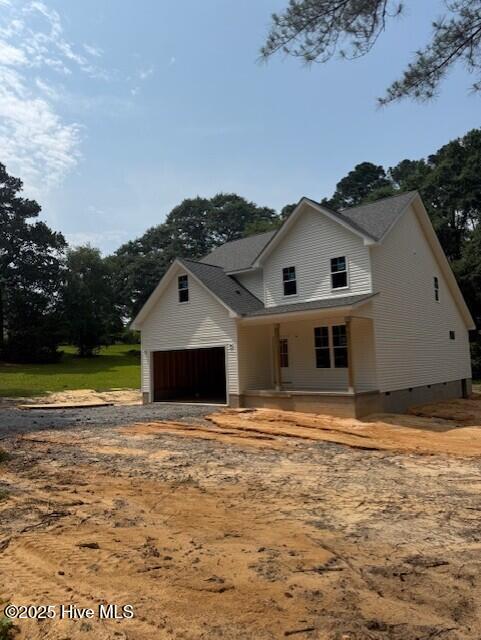 300 N Alma St, Vass, NC 28394 - view of front of home featuring a garage, driveway, a porch, and crawl space