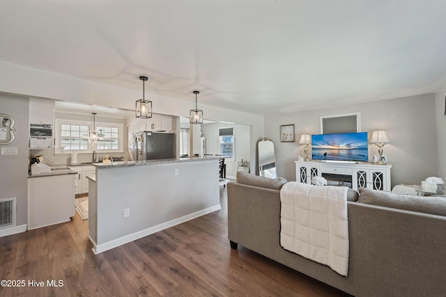 722 Christine Ave, Jacksonville, NC 28540 - living room with dark wood-style flooring, baseboards, and visible vents