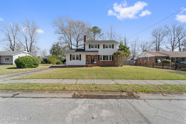 722 Christine Ave, Jacksonville, NC 28540 - view of front facade featuring fence, a chimney, a front yard, brick siding, and driveway