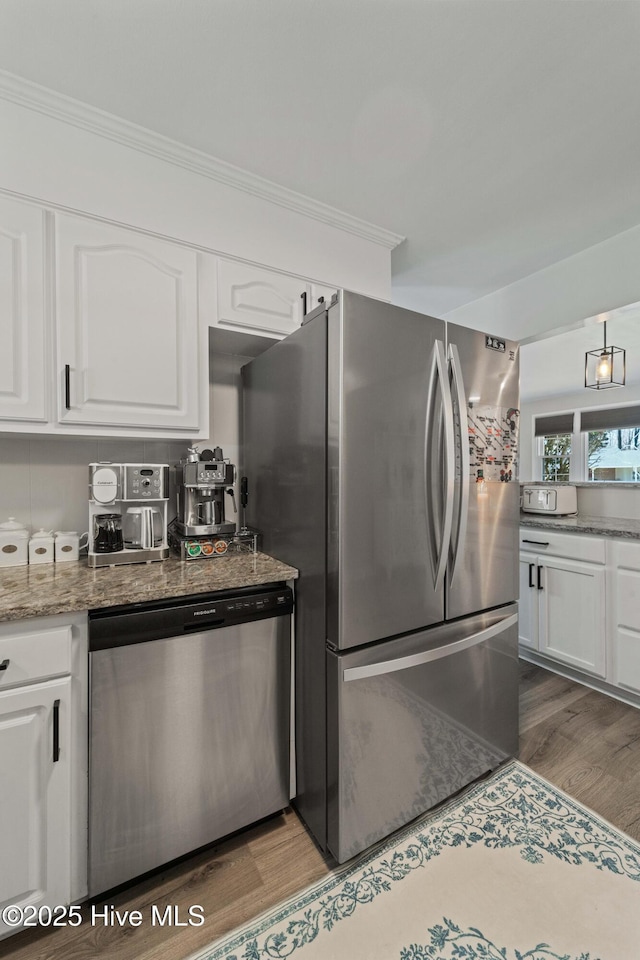 722 Christine Ave, Jacksonville, NC 28540 - kitchen featuring white cabinetry, stainless steel appliances, crown molding, and wood finished floors
