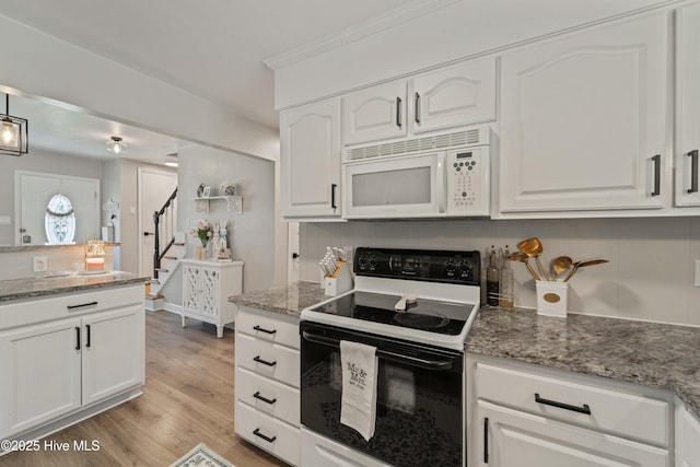 722 Christine Ave, Jacksonville, NC 28540 - kitchen with electric range, light wood-style flooring, white cabinetry, and white microwave