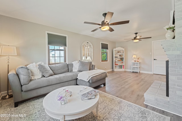 722 Christine Ave, Jacksonville, NC 28540 - living area featuring light wood-type flooring, baseboards, a healthy amount of sunlight, and ceiling fan