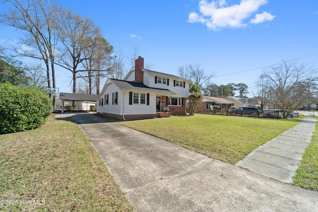 722 Christine Ave, Jacksonville, NC 28540 - view of front facade featuring a chimney, a trampoline, concrete driveway, an attached carport, and a front lawn