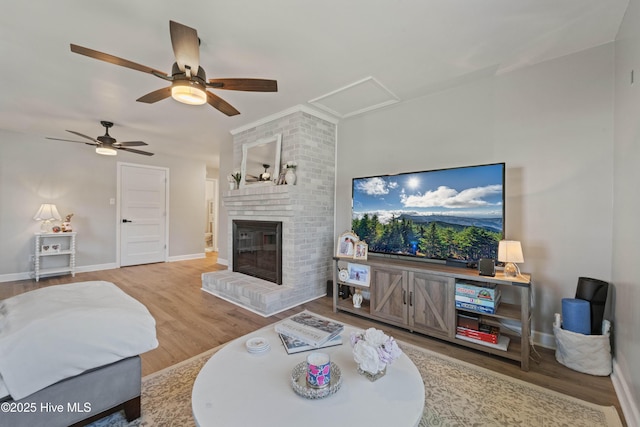 722 Christine Ave, Jacksonville, NC 28540 - living area with baseboards, wood finished floors, a ceiling fan, and a brick fireplace