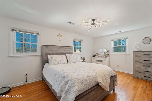 722 Christine Ave, Jacksonville, NC 28540 - bedroom featuring a chandelier, baseboards, light wood finished floors, and visible vents