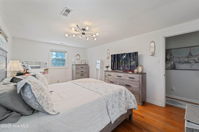 722 Christine Ave, Jacksonville, NC 28540 - bedroom with baseboards, visible vents, a chandelier, and wood finished floors